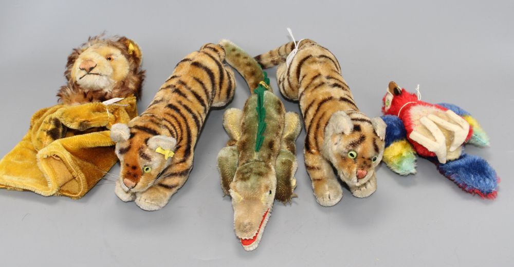 Two 1950s Steiff tigers, a crocodile, a parrot and a lion glove puppet